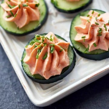 Salmon mousse is served on top of cucumber slices.