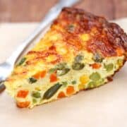 Crustless vegetable quiche is served with a fork.