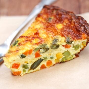 Crustless vegetable quiche is served with a fork.