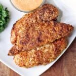 Almond flour chicken tenders are served with a dip.