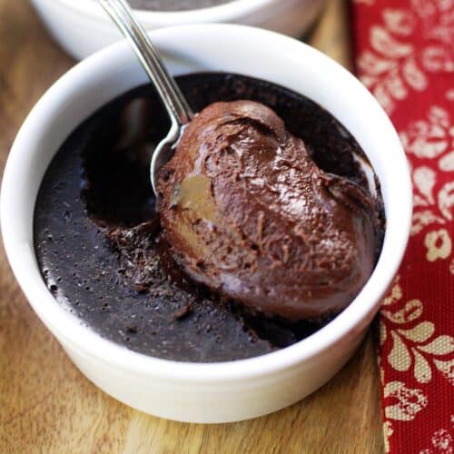 Chocolate custard is served with a silver spoon.
