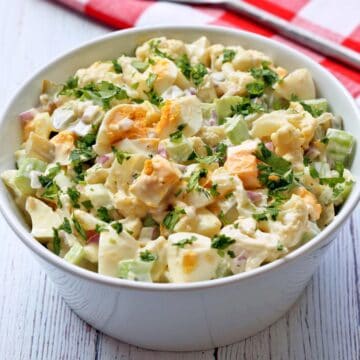 Cauliflower potato salad is served in a white bowl.