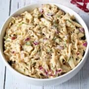 Crab salad is served in a white bowl with a napkin.