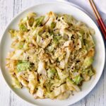 Cabbage stir fry is served with chopsticks.