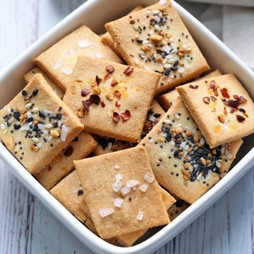 Almond flour crackers are served in a white bowl.