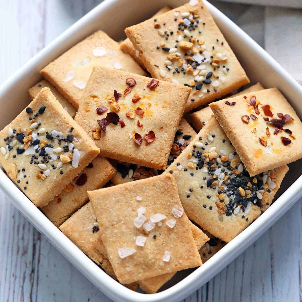 Almond flour crackers are served in a white bowl.