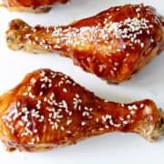 Teriyaki chicken drumsticks are topped with sesame seeds.