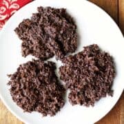 Coconut haystacks are served on a white plate.