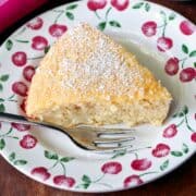 Keto coconut cake is served on a plate with a fork.