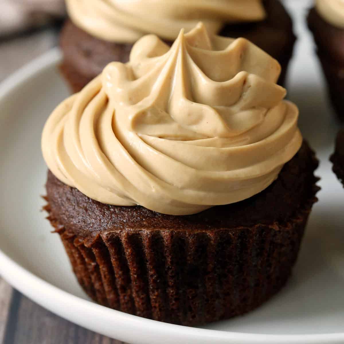 Keto chocolate cupcakes are topped with frosting.