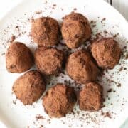 Keto truffles are served on a white plate.