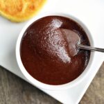 Keto hazelnut spread is served with toast and a spoon.