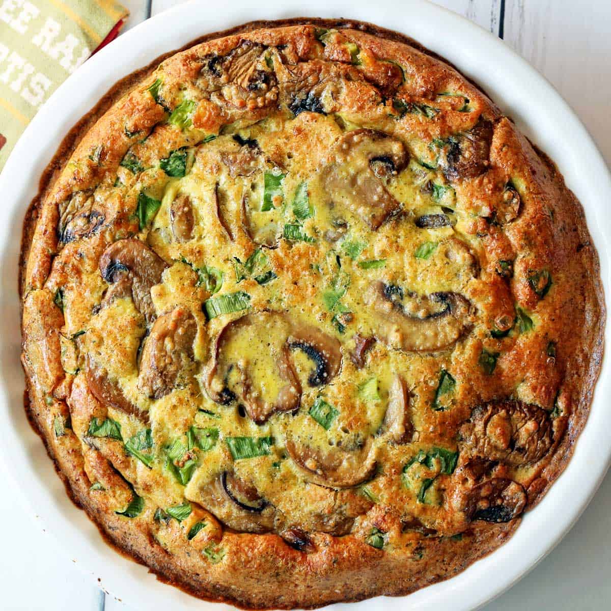 Mushroom frittata is served in a white baking dish.