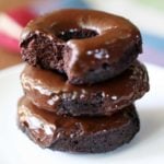 Keto donuts are stacked on a white plate.