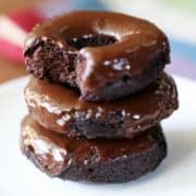 Keto donuts are stacked on a white plate.