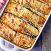 Zucchini lasagna is served in a white baking dish.