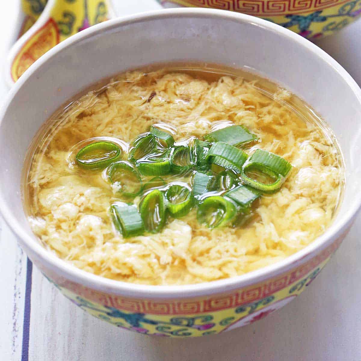 Egg drop soup is served in a Chinese-style bowl.