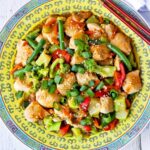 Chicken stir-fry is served on a Chinese-style plate.