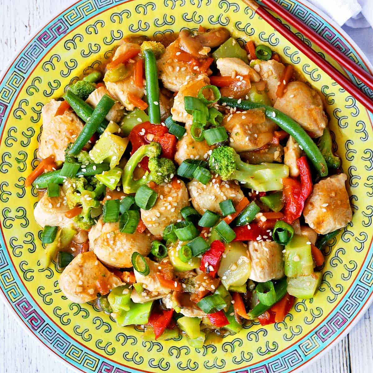 Chicken stir-fry is served on a Chinese-style plate.