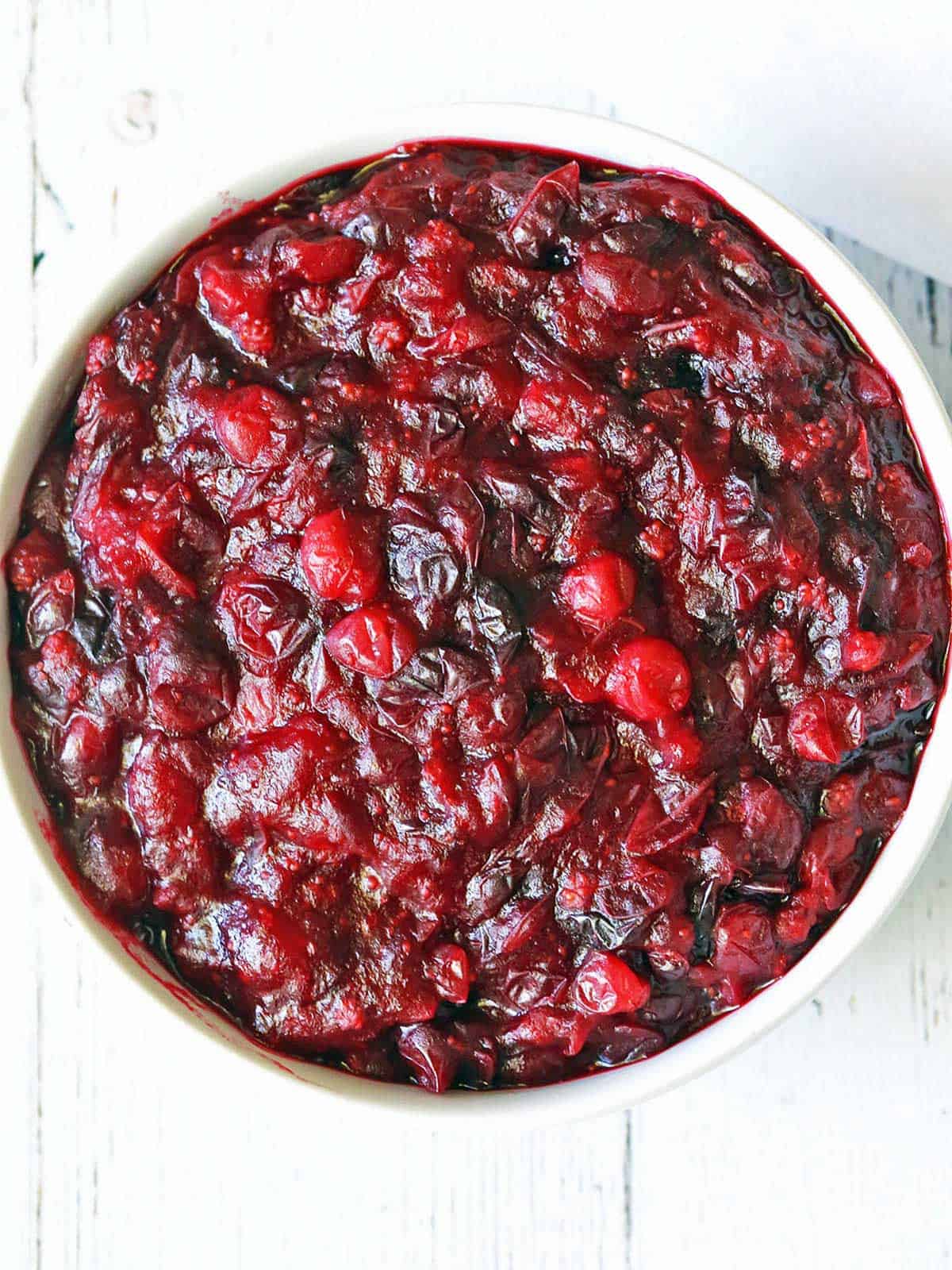 Sugar-free cranberry sauce is served in a white bowl. 
