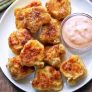 Keto chicken nuggets are served with a dipping sauce.