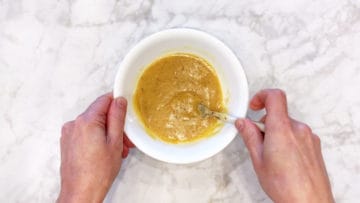 Mixing the sauce in a bowl.