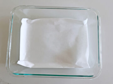 A parchment-lined pan for keto cornbread.