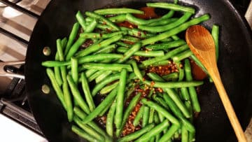 Adding the sauce to the skillet.