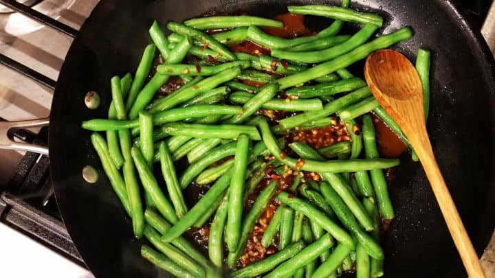 Adding the sauce to the skillet.