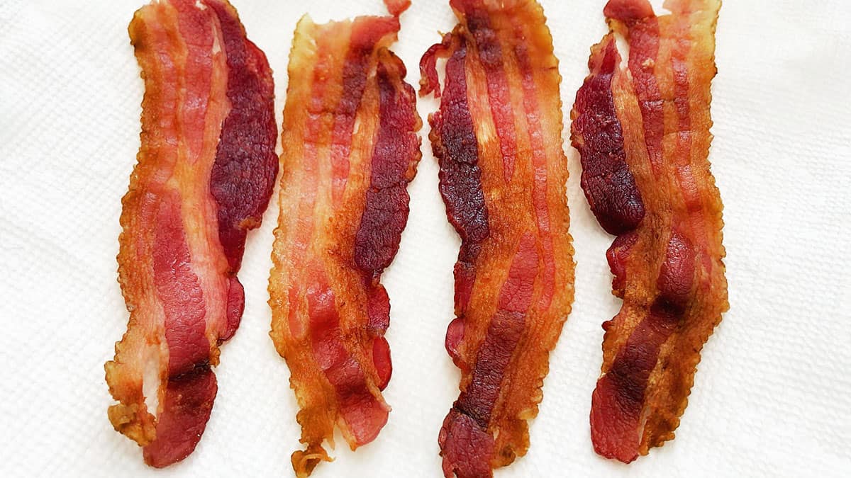 The bacon is ready - served on paper towels.