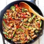 Pork stir fry is served in a cast-iron skillet.