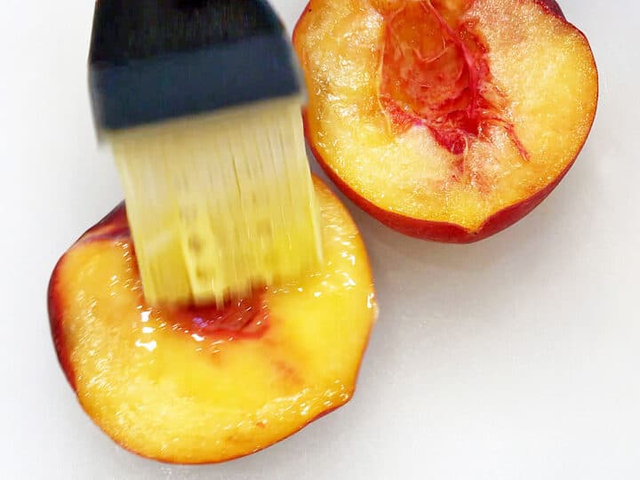 Brushing a peach with melted butter.