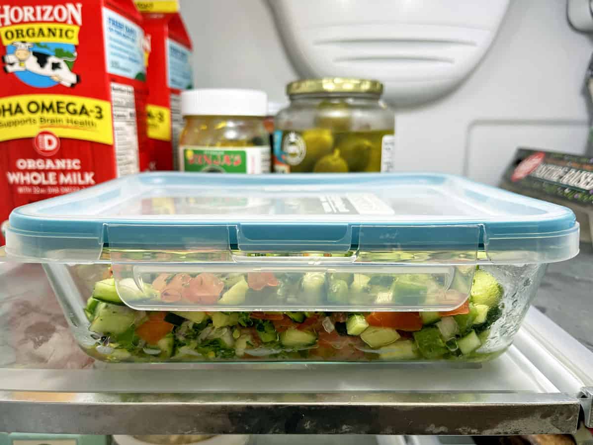 Israeli salad is stored in an airtight container in the fridge.