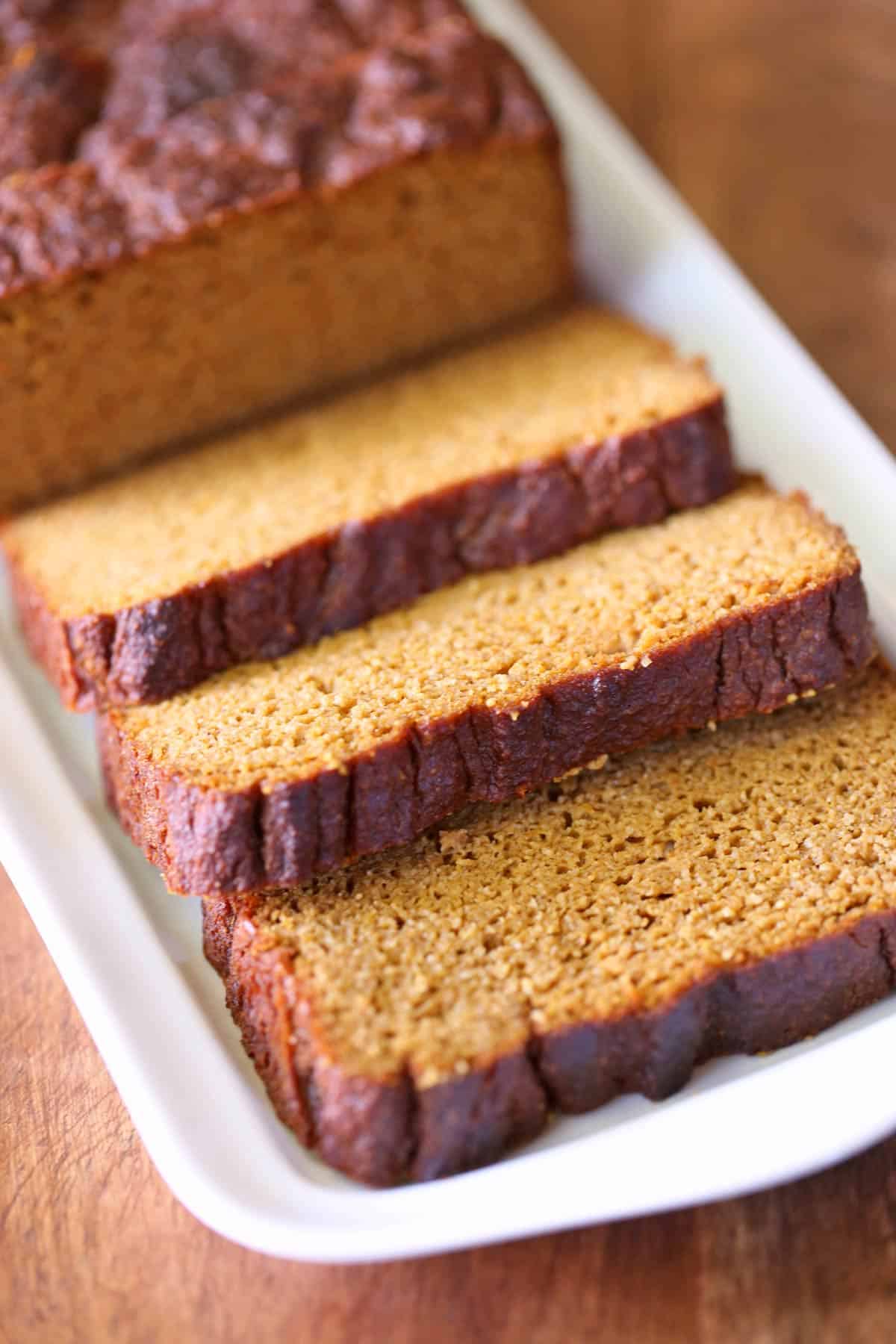 Keto pumpkin bread is served on a white serving tray.