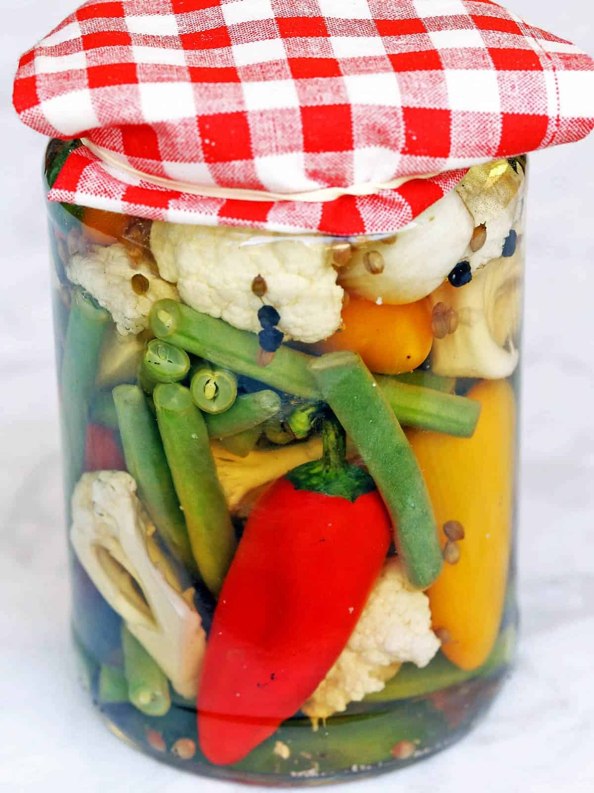 Quick pickles served in a glass jar.