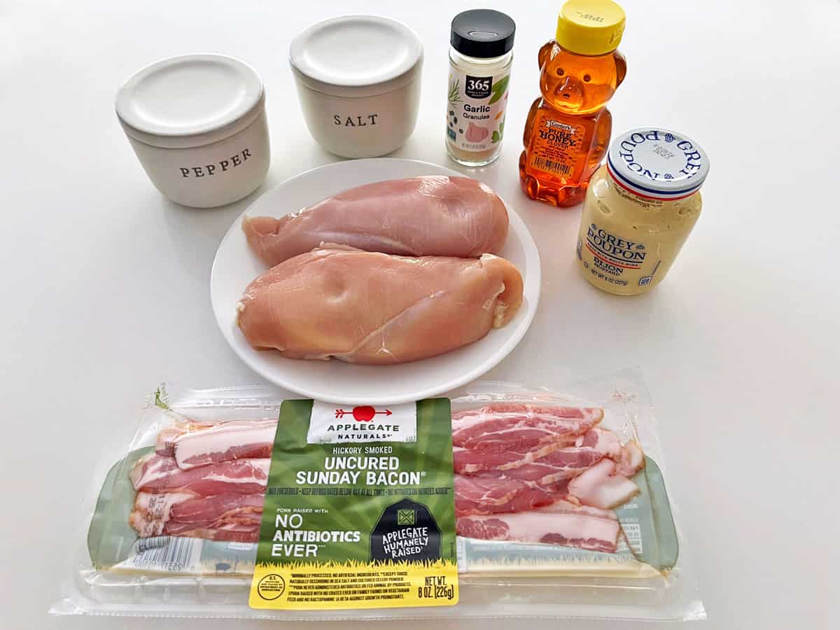 The ingredients needed to make bacon-wrapped chicken breast.