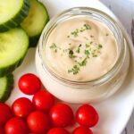 Tahini sauce is served with fresh-cut veggies.