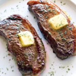 Picanha steak is topped with butter.