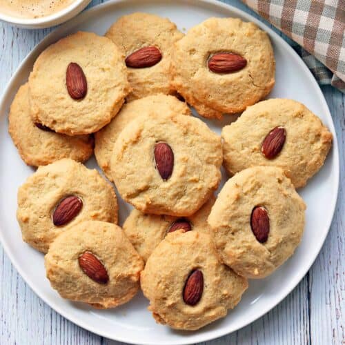 Almond flour cookies are served with a cup of coffee.