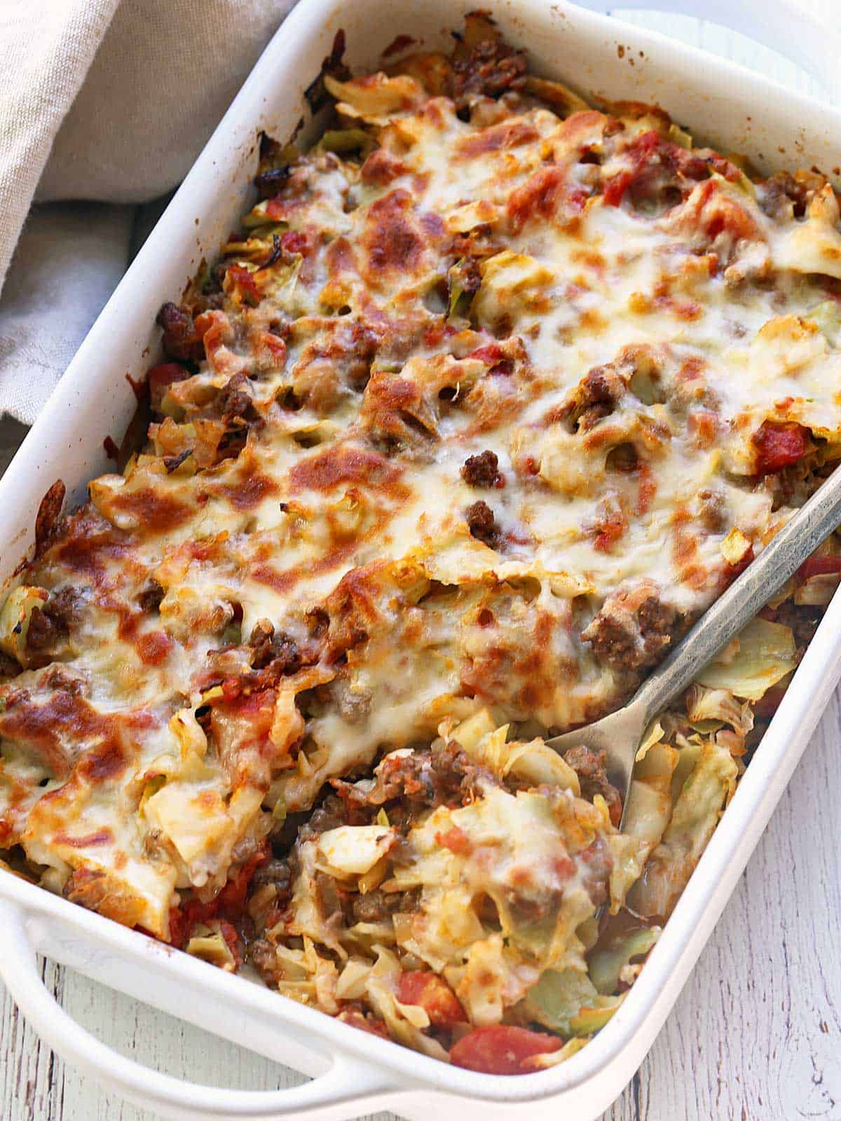Cabbage casserole served in a white baking dish. 