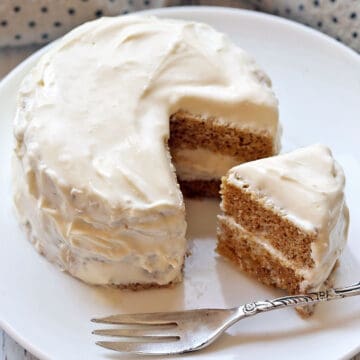 Keto mug cake is served on a white plate with a fork.