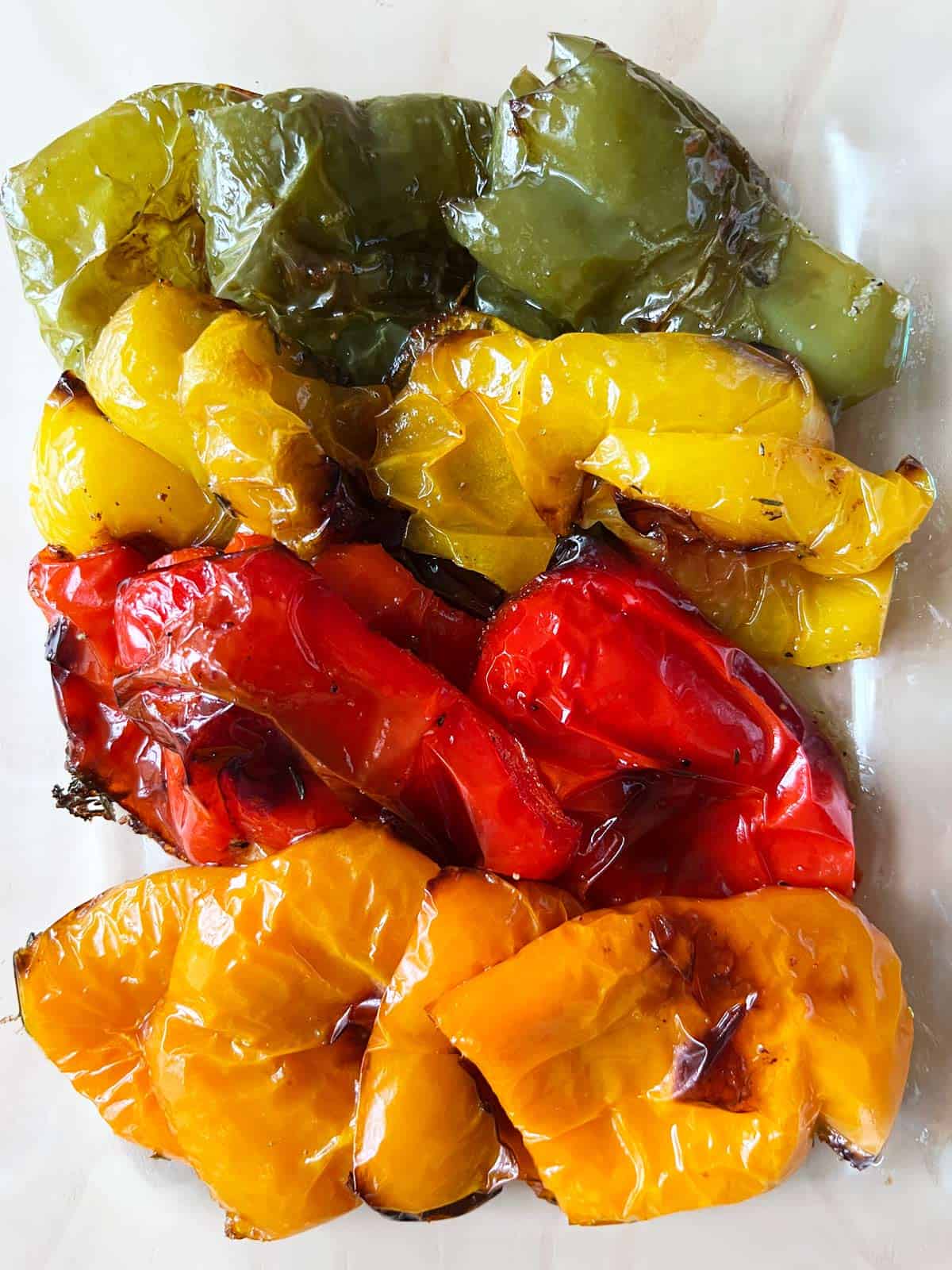 Roasted peppers leftovers stored in a glass container.