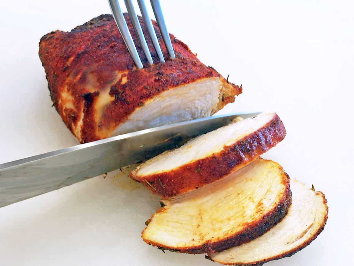 Slicing the fully cooked blackened chicken.