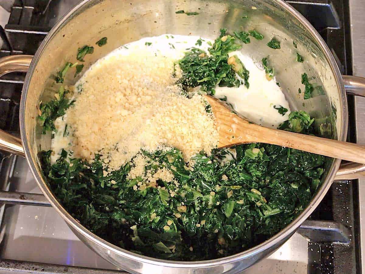 Spinach with cream and parmesan in a saucepan.