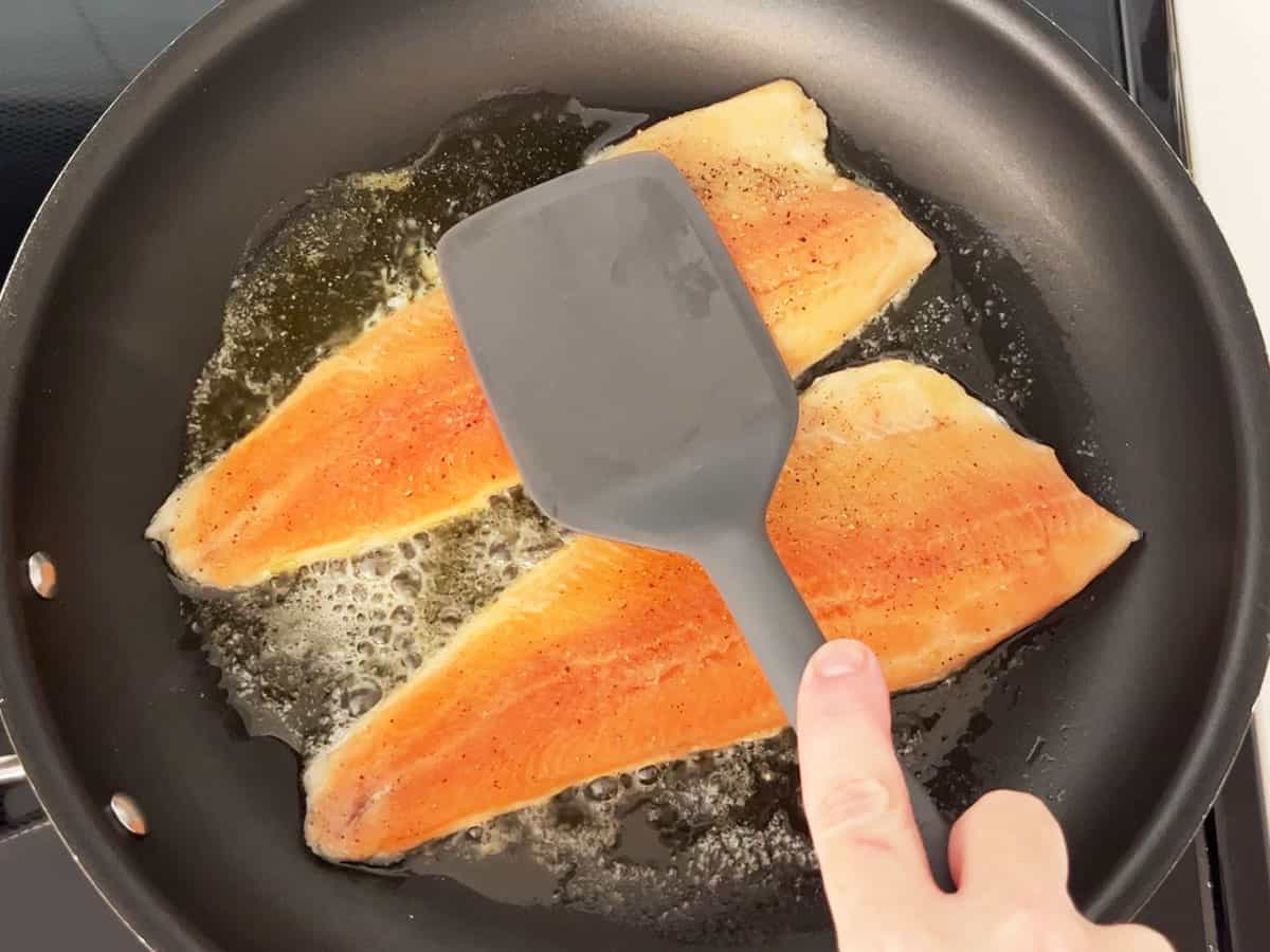 Cooking rainbow trout skin side down.