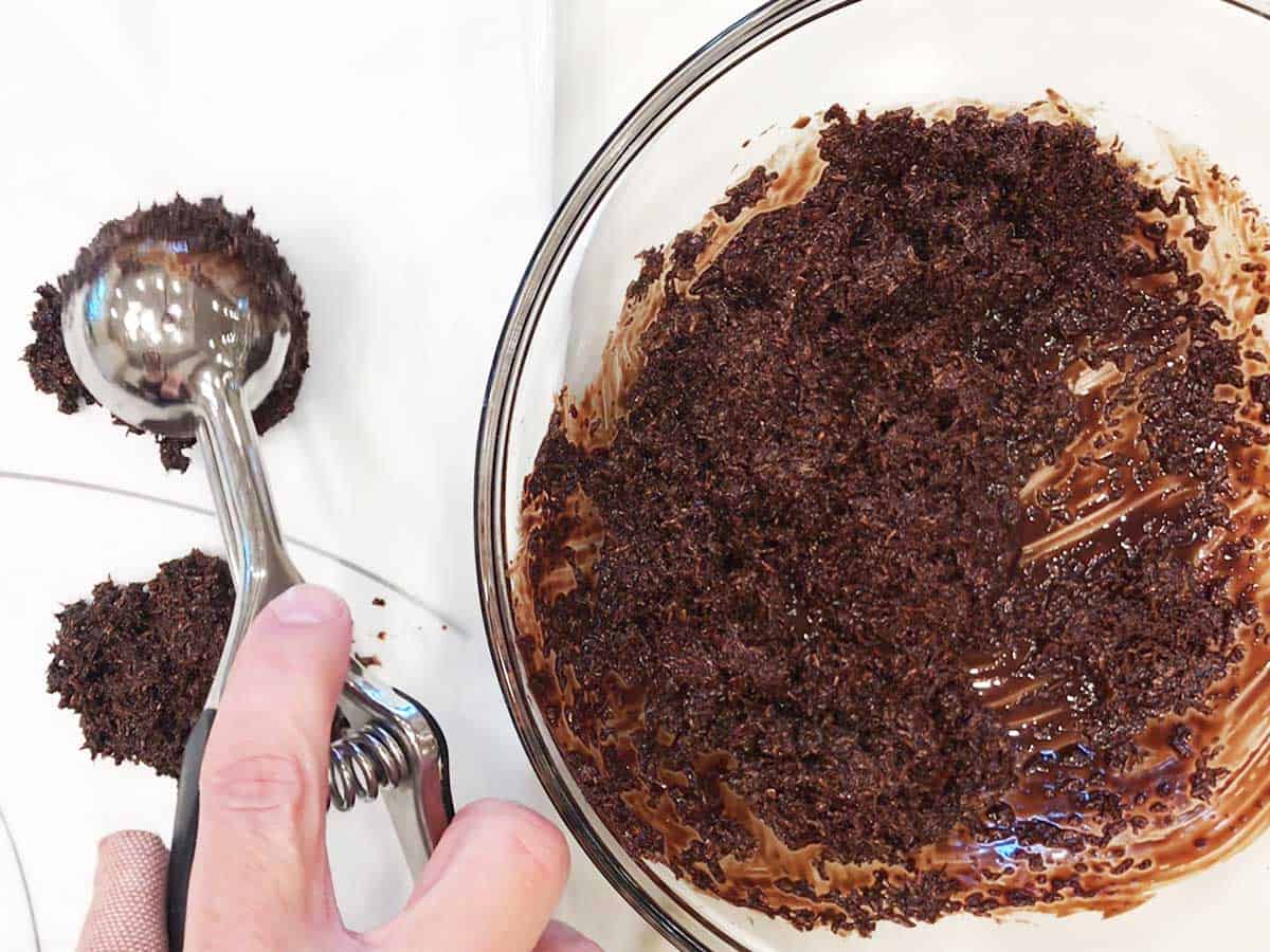 Dropping mounds of the mixture onto wax paper. 