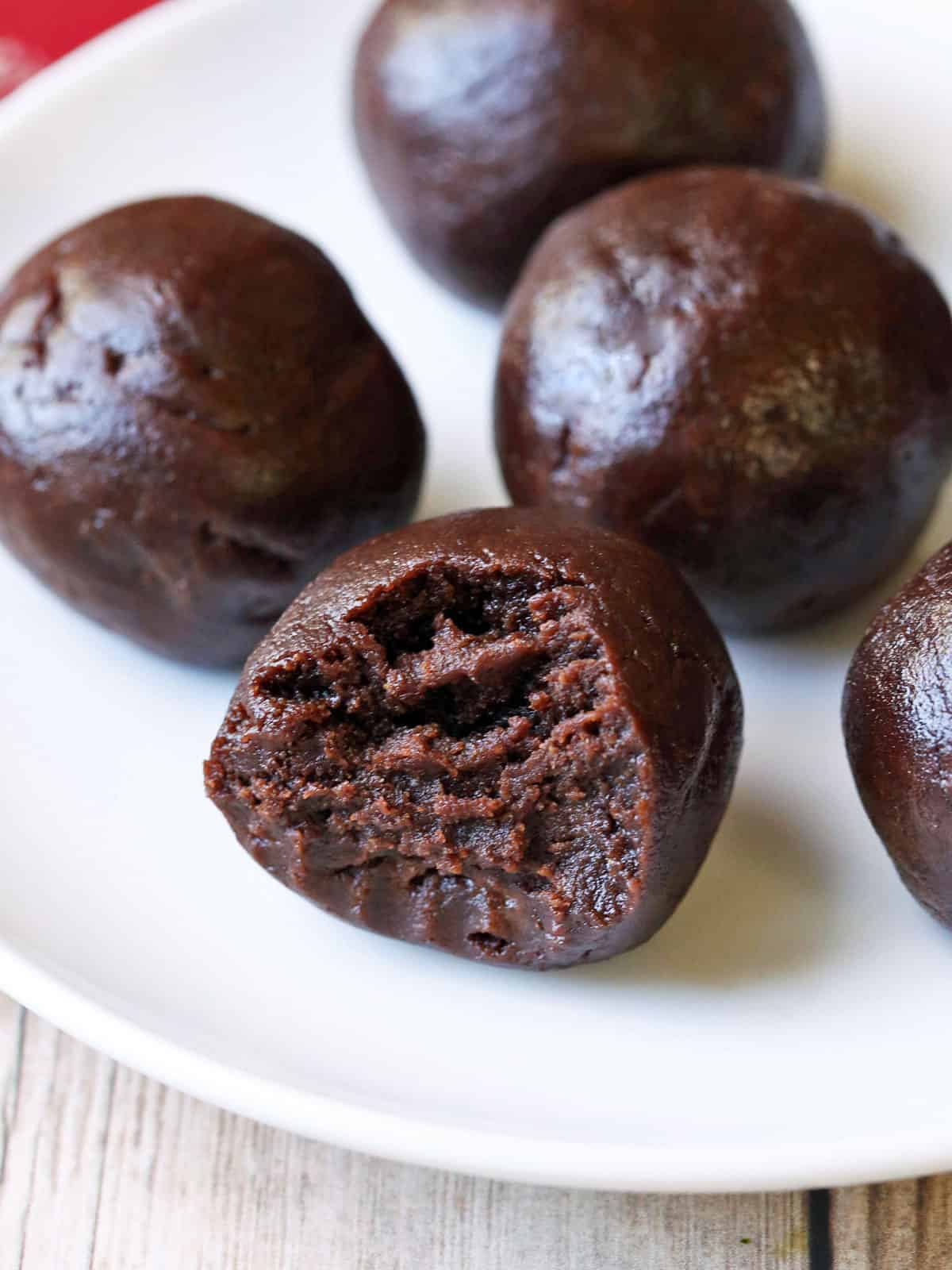 Keto fat bombs are served on a white plate. 