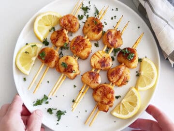 The scallops are served on a white plate.