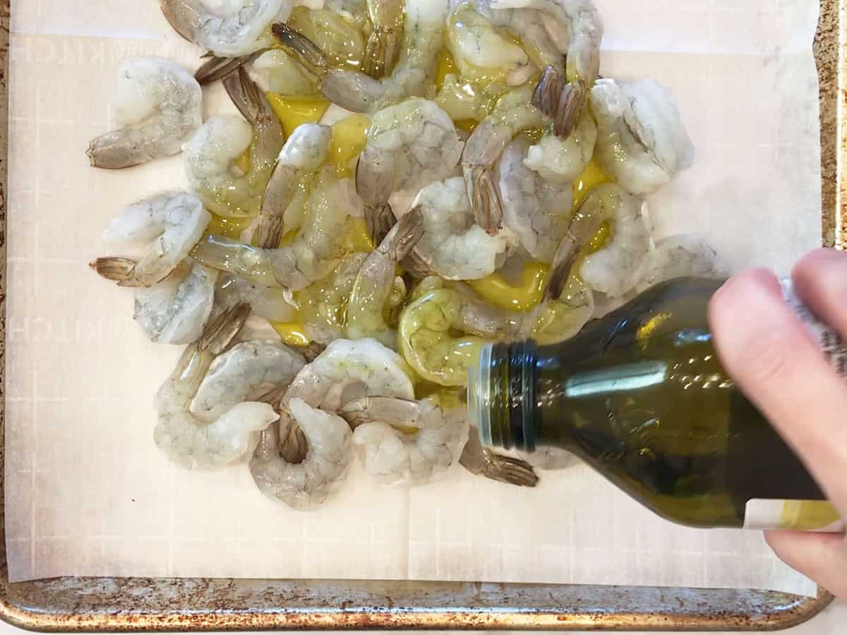 Add olive oil to shrimp in the pan.