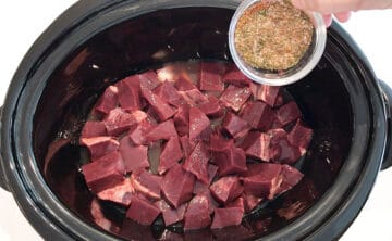 Adding spices to slow cooker.